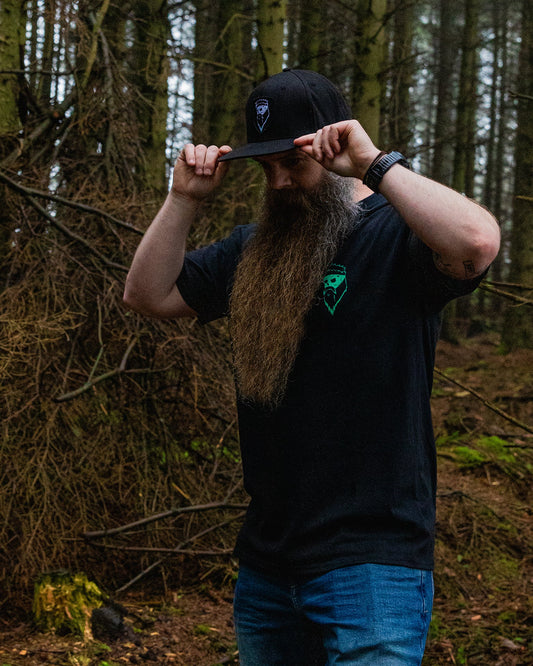 bearded man in woods with rough beard