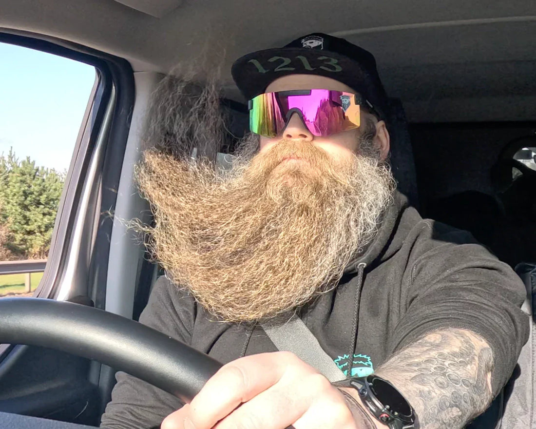 man with thick beard driving